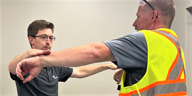 AT_blog 6_main Athletic trainer helping an employee