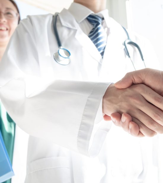 Doctor and business people shaking hands